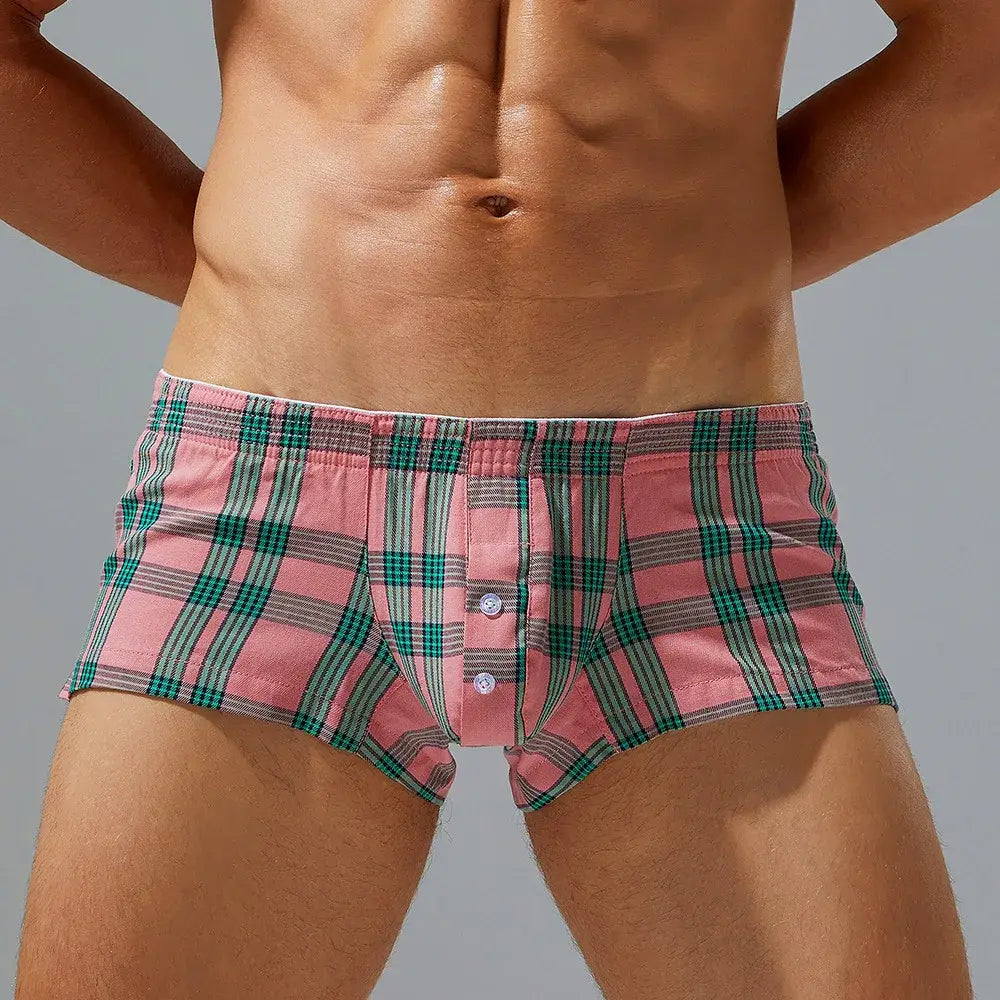 Men plaid boxer shorts lounge pants in pink and green plaid with a button front design suitable for comfortable lounging.