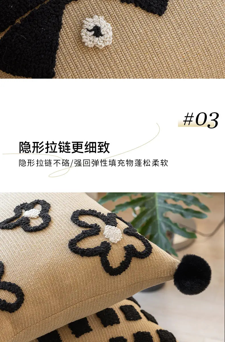 Housse de coussin bohème en tricot beige, avec des fleurs brodées en noir et des centres blancs, terminée par un pompon noir moelleux, pour la décoration du salon.