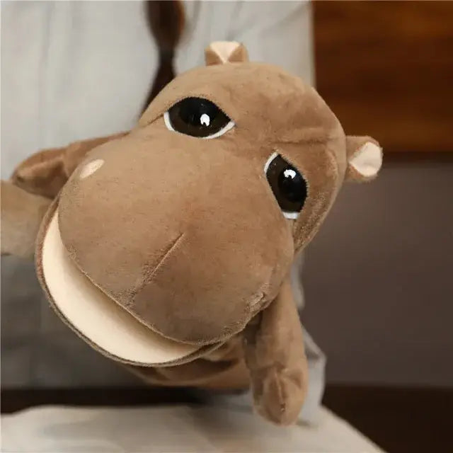 A plush brown hippo hand finger puppet made of soft velour material with large black button eyes designed as an educational baby toy within the lion elephant bunny collection.