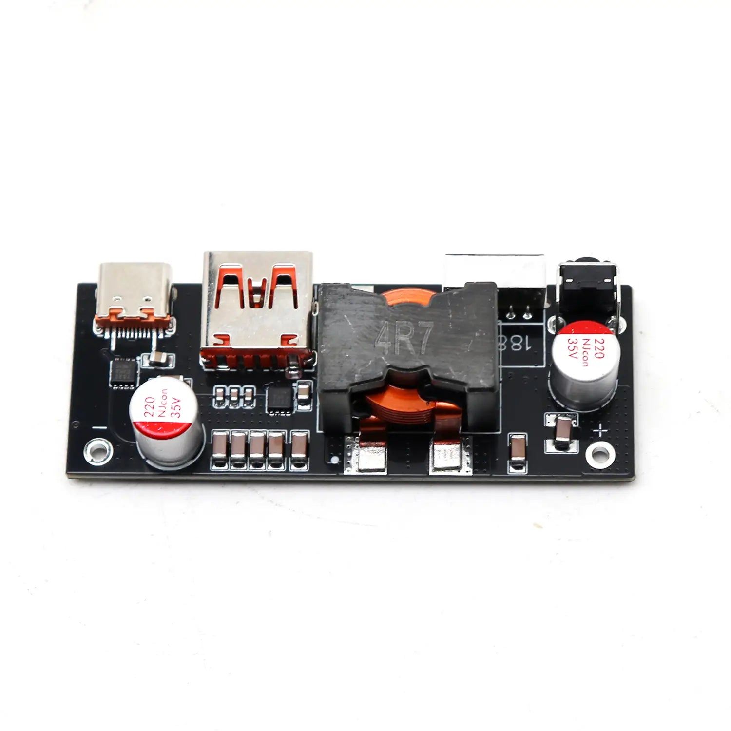 Black rectangular usb charging board with silver and orange connectors red capacitors labeled 220 nicon 35v and a central black transformer in a 100w pd3.1 fast charger power bank module bms.