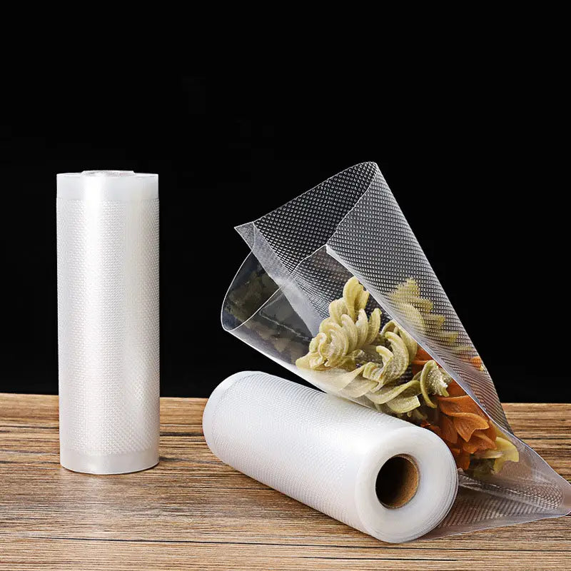 clear textured food vacuum sealer rolls and storage bags in white plastic film with one partially opened bag containing dried pasta for efficient food vacuum storage.