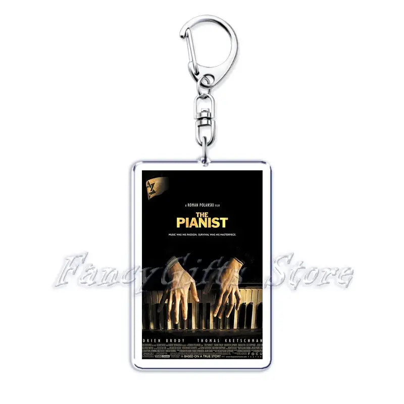 silver rectangular acrylic keychain featuring a printed movie poster for the pianist in black and gold design from the movie poster acrylic keychain set