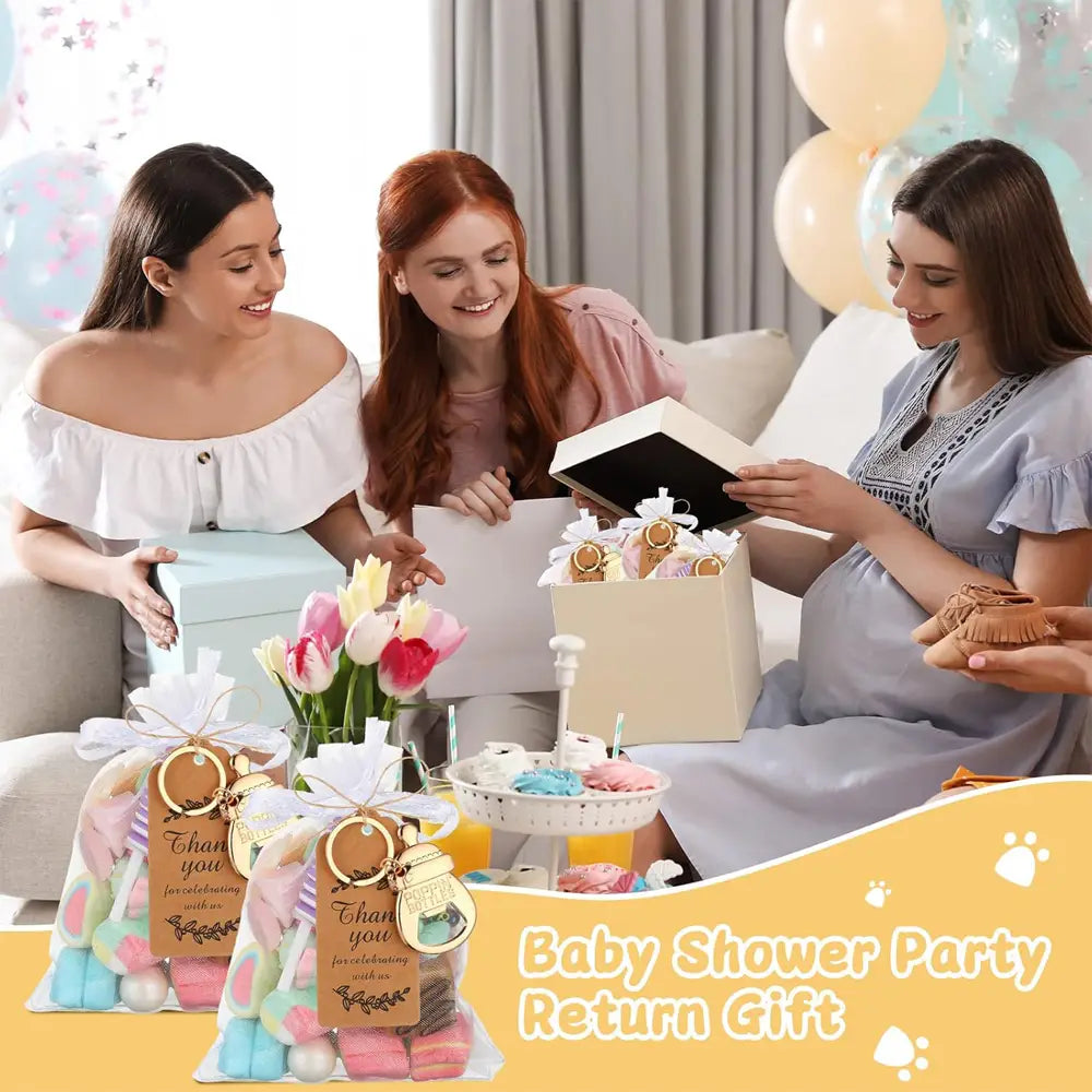 Pastel-colored baby shower return gift bags filled with colorful packaged items and adorned with gold-toned keychain bottle opener favors.