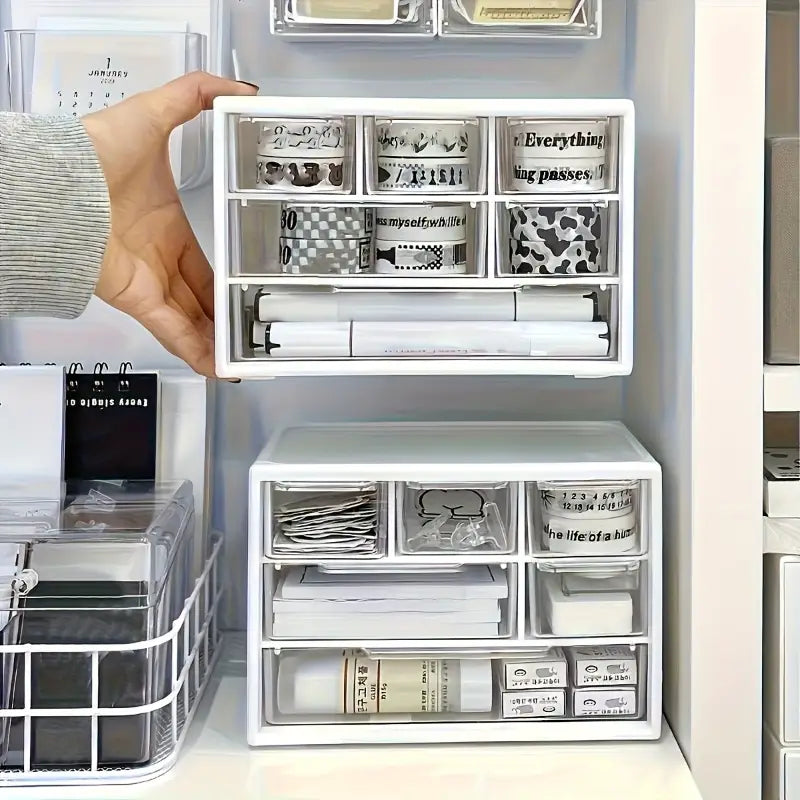 Organisateur de bureau en plastique blanc à tiroirs transparents contenant divers articles de papeterie pour un usage au bureau ou pour les études