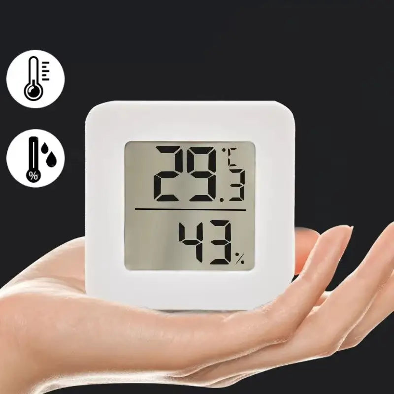 white square digital weather desktop alarm clock displaying temperature 29.3 celsius and humidity 43 percent