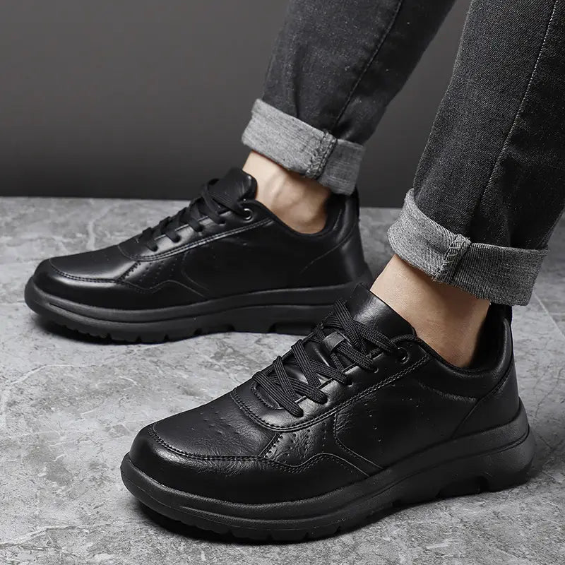 Men black leather chunky sole sneakers featuring a sleek modern design and sturdy rubber soles.