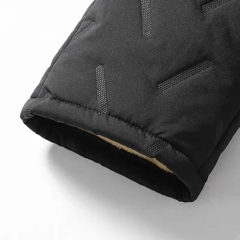 Black quilted winter glove with soft beige fleece lining and subtle gray stitched accents paired with men fleece lined thermal sweatpants waterproof winter pants for cold weather use.