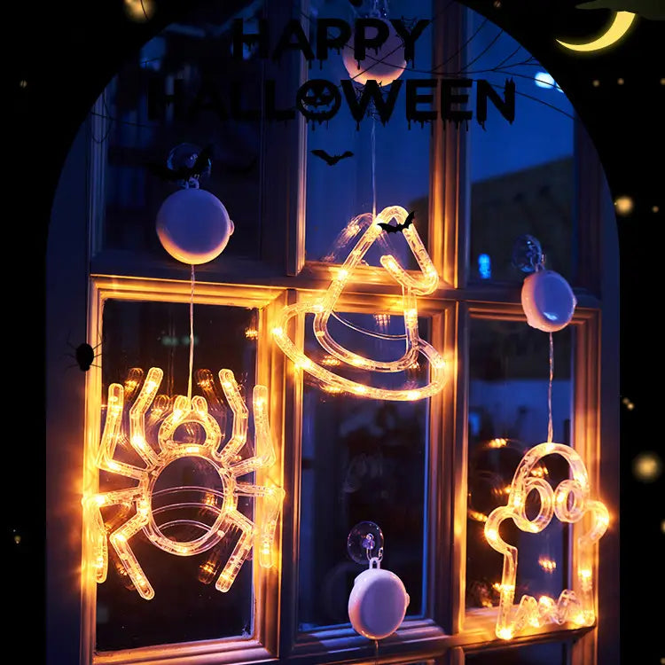 Halloween window light battery operated pumpkin ghost decor featuring a warm yellow illuminated led display with glowing spider witch hat and ghost shapes.