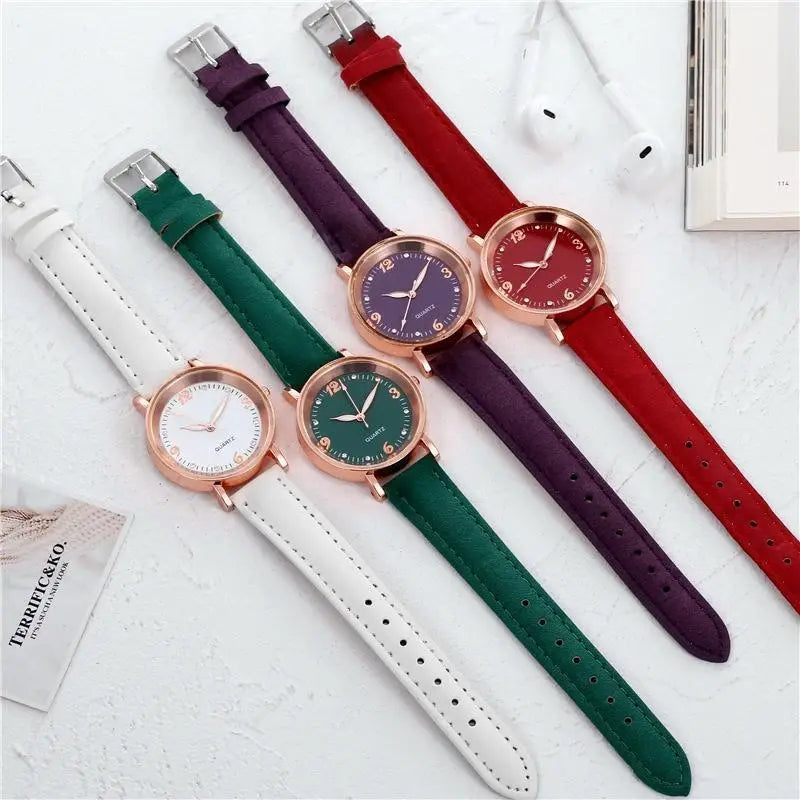 Four elegant women quartz watches with rose gold dials and colorful suede leather bands in white green purple and red.