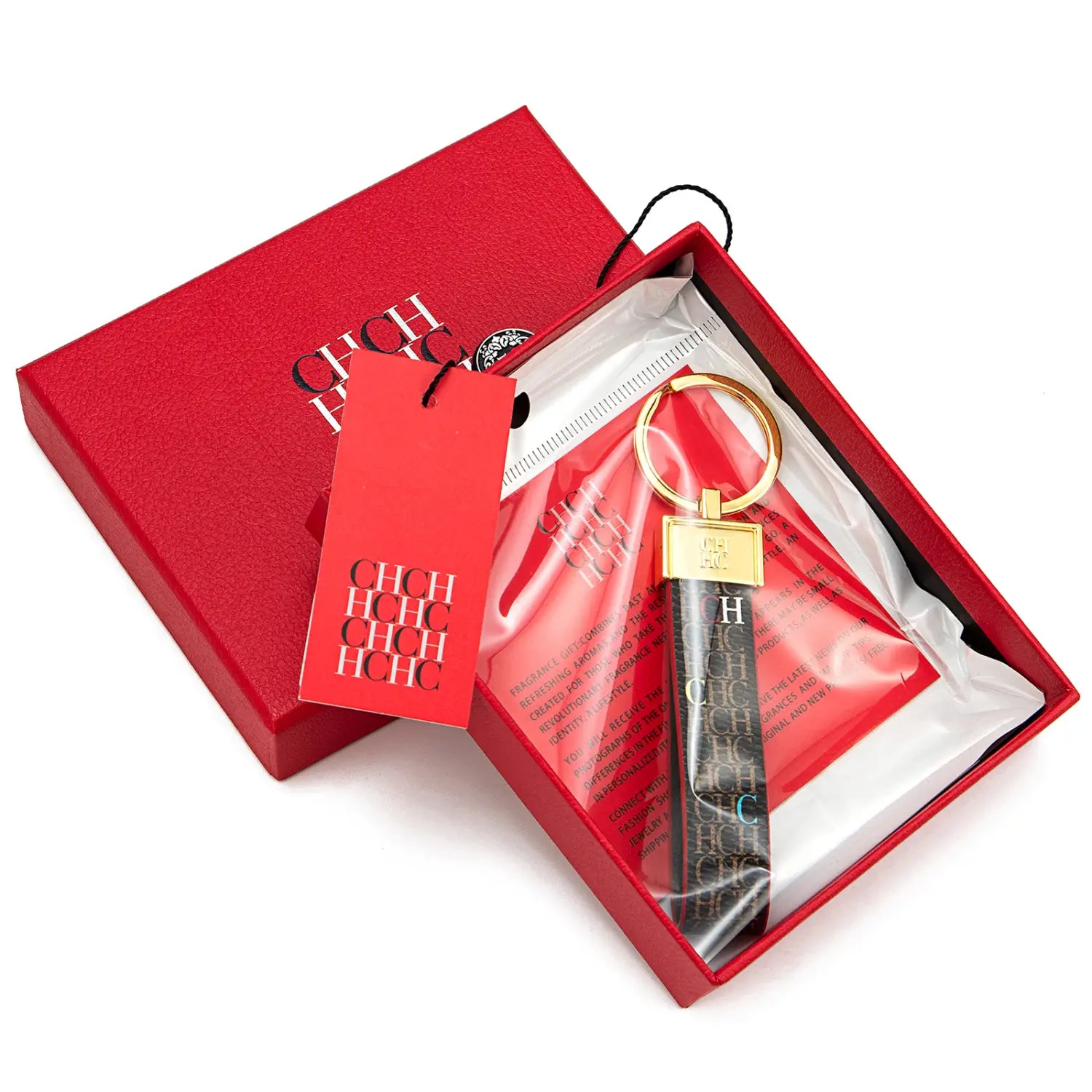 Black leather keychain with gold-tone metal ring and rectangular plaque featuring repeating hchc monogram in silver lettering for designer fashion accessory gift.