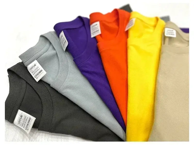 Un ensemble de t-shirts vintage à motif de voiture de muscle en coton uni et coloré, dans diverses teintes unies, notamment noir, gris, violet, orange, jaune et beige.