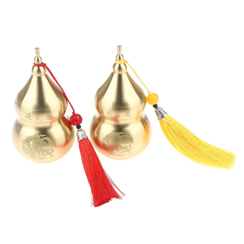 Brass gourd feng shui prosperity ornament featuring golden metallic engraved dragon designs and tassels.