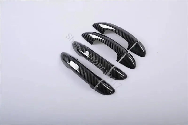 Black carbon fiber textured door handle cover trims designed for VW Passat car doors.