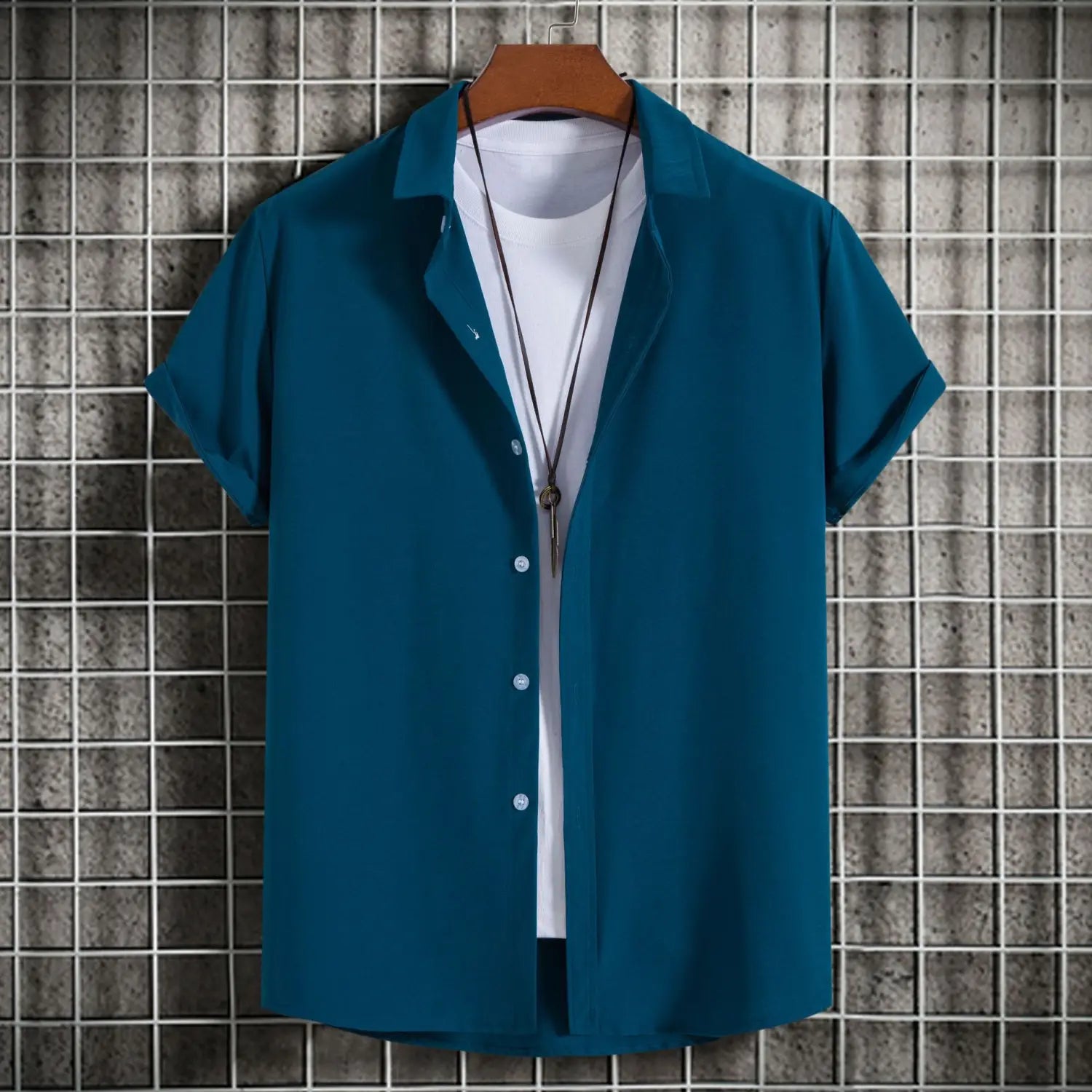 chemises à manches courtes vert turquoise pour homme, style mode, unies, décontractées, chemises de plage avec boutonnage, affichées sur un cintre en bois, portées au-dessus d’un t-shirt blanc