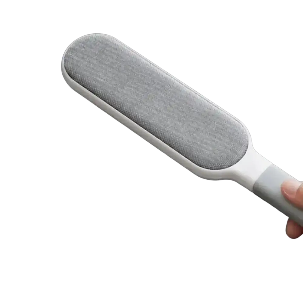 Gray fabric-covered double-sided pet hair remover with white handle for sofa and clothing cleaning