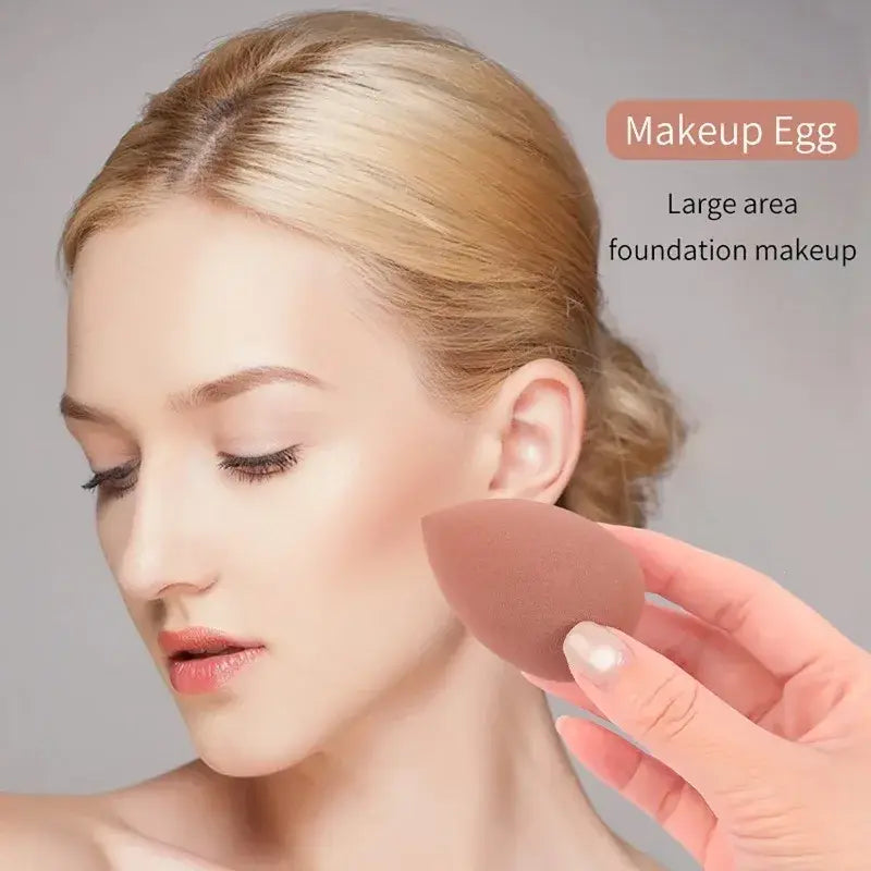 a soft peach-colored silicone makeup egg from the makeup brush and sponge set 46 piece pink designed for large-area foundation and makeup application