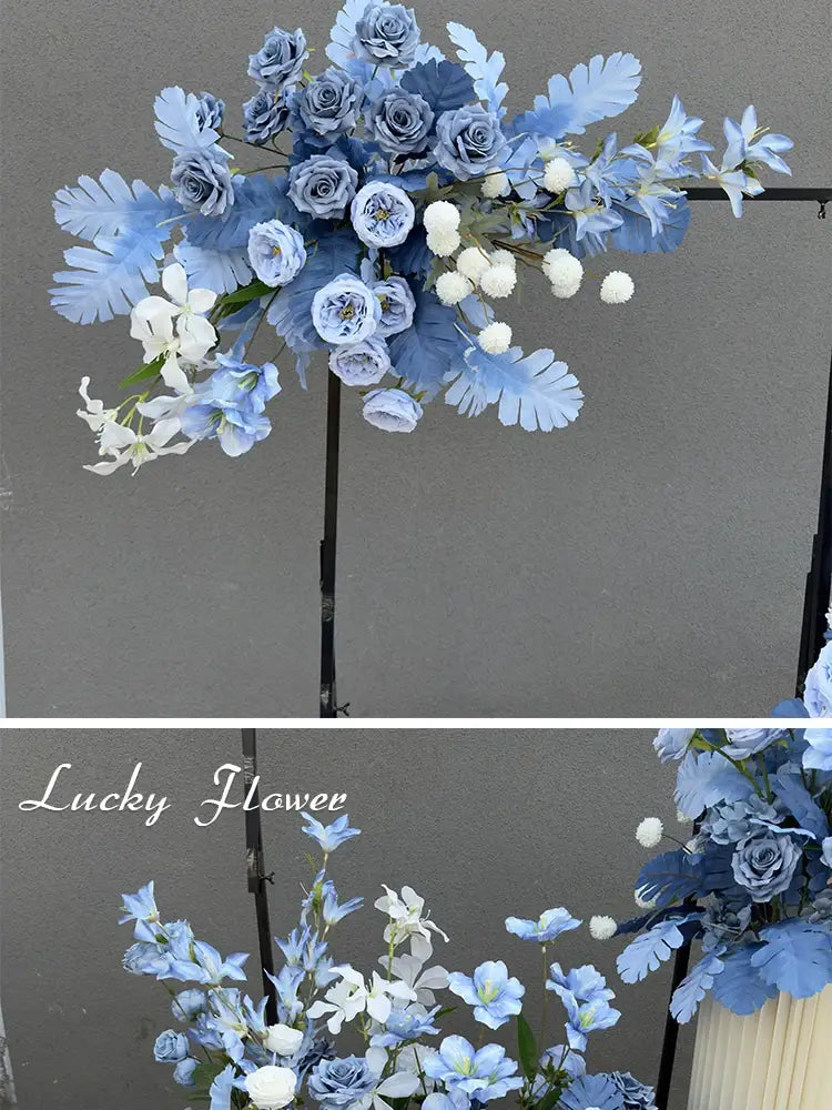 A delicate arrangement of artificial flowers featuring blue and white roses hydrangeas and foliage in a pastel palette for a wedding arch floral backdrop.