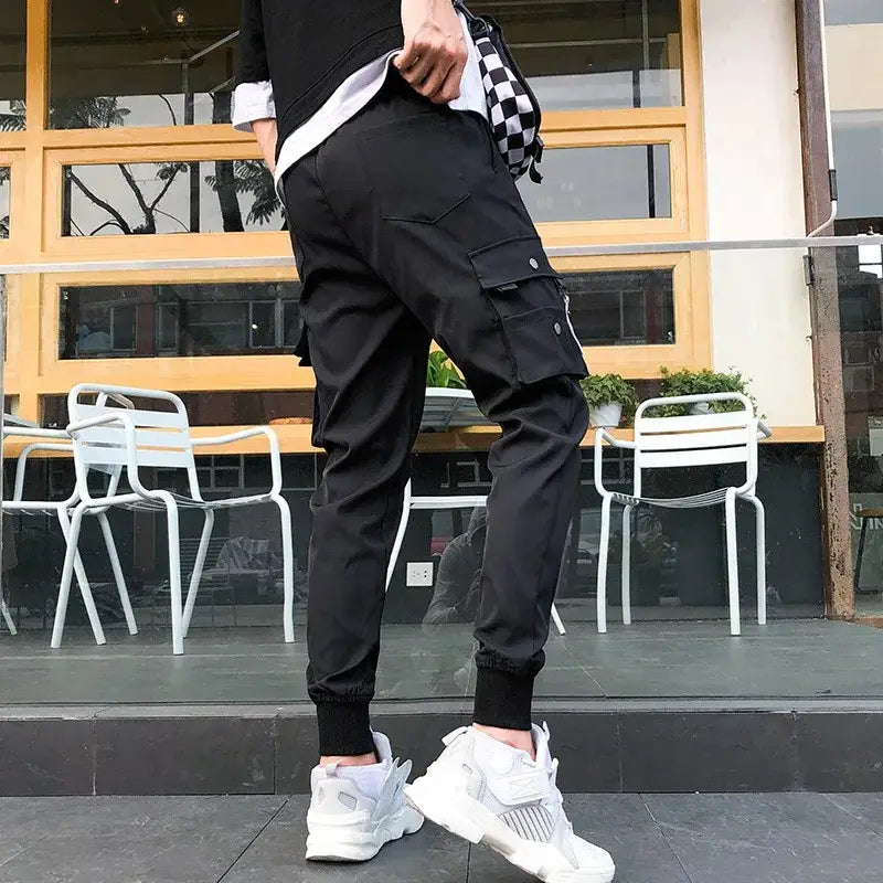 Men tactical cargo pants black with multiple pockets and elastic cuffs designed for durability and practical use.