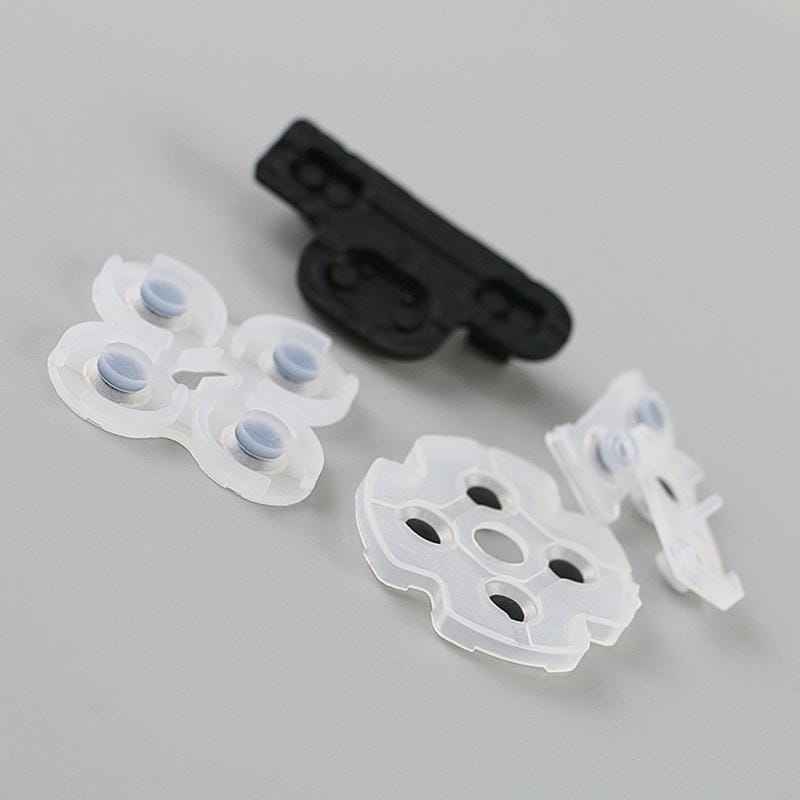 Weiße Kunststoff-Saugkuppeln mit grauen leitfähigen Gummipads und einer schwarzen Kunststoff-Befestigungshalterung in einem leitfähigen Gummipol-Set für den PlayStation-3-Controller