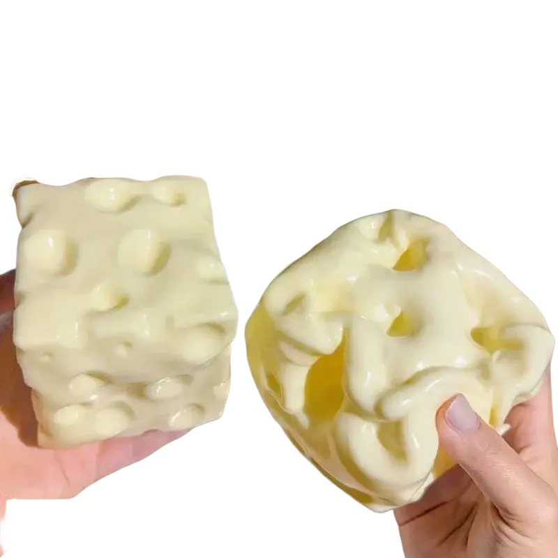 Creamy white cheese-themed stress relief squishy toy with swiss cheese hole texture and flexible tpr material front view