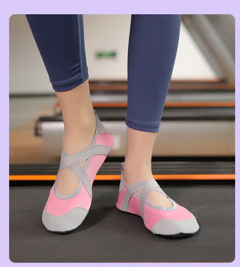 women yoga shoes anti-slip fitness flats in pink and gray with crossover straps designed for dance and exercise use.