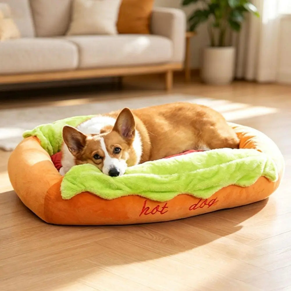 orange plush hot dog-shaped pet bed with green lettuce and red sauce accents designed as a cozy resting place for cats and dogs.
