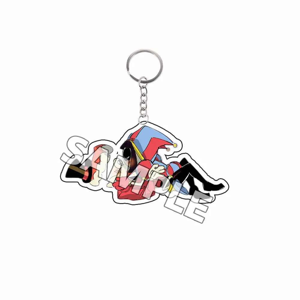Llavero acrílico colorido que presenta un personaje de bufón de estilo anime con atuendo rojo y azul, con acentos negros; indicado como producto terminado en la colección de personajes tipo Tadc.