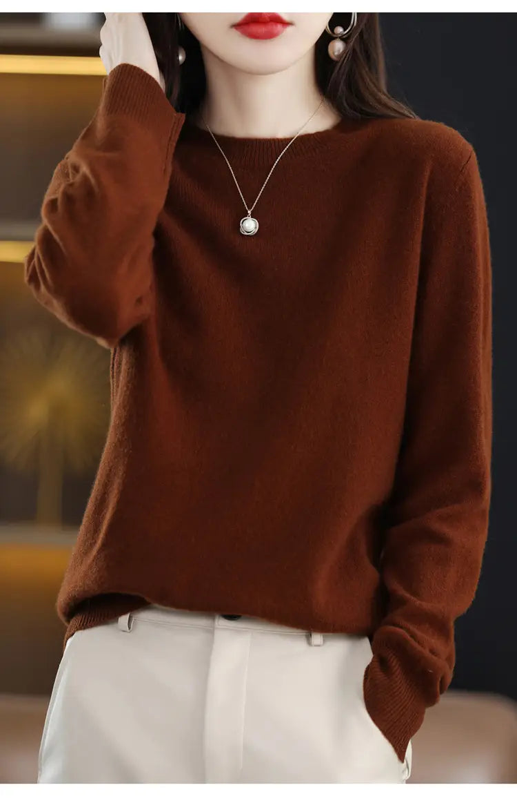 A cozy rust-colored pure wool cashmere o-neck pullover sweater with a soft texture and relaxed fit.