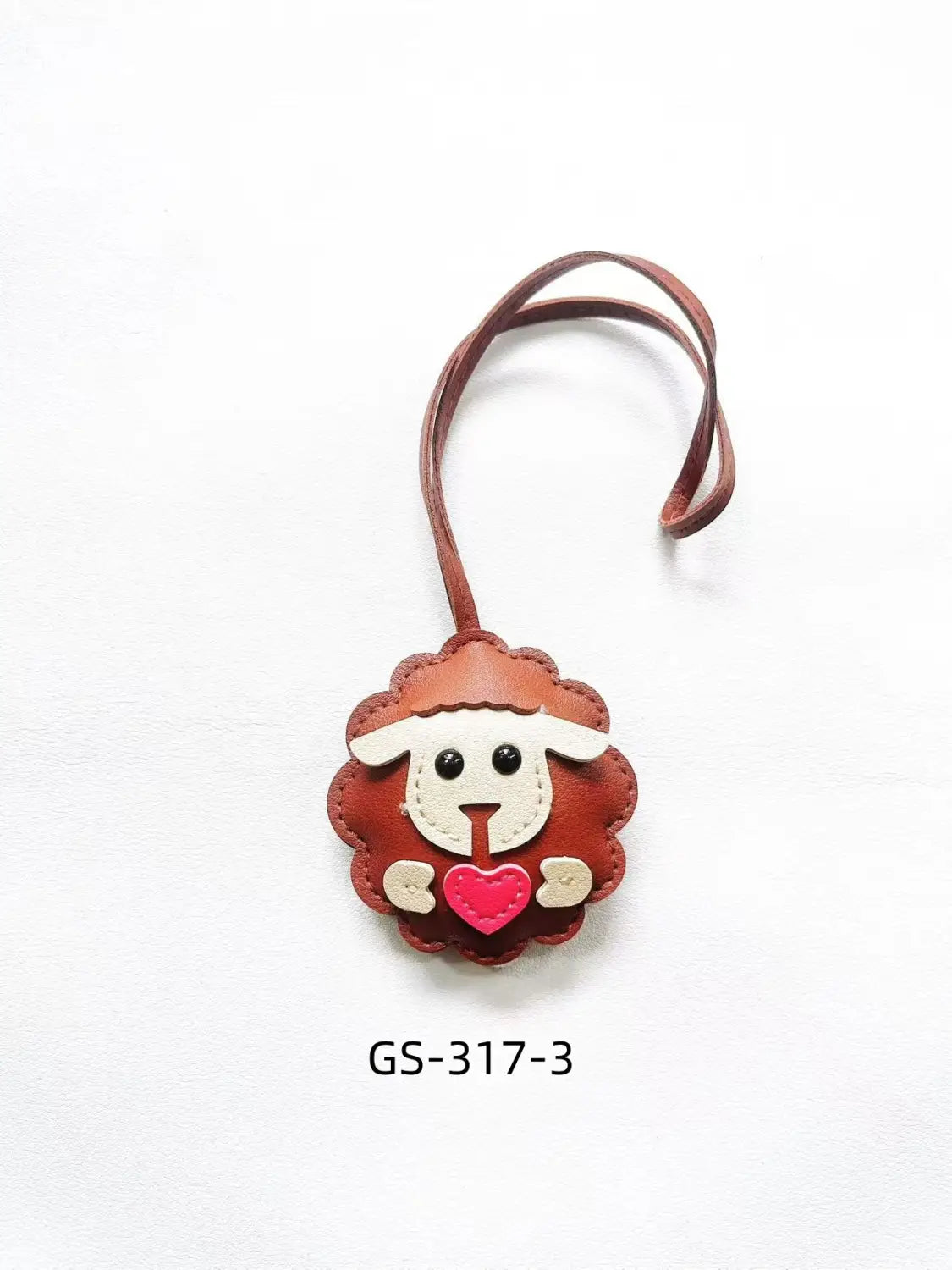 Cute brown leather sheep-shaped keychain with white facial features and a pink heart accent perfect as a bag charm.