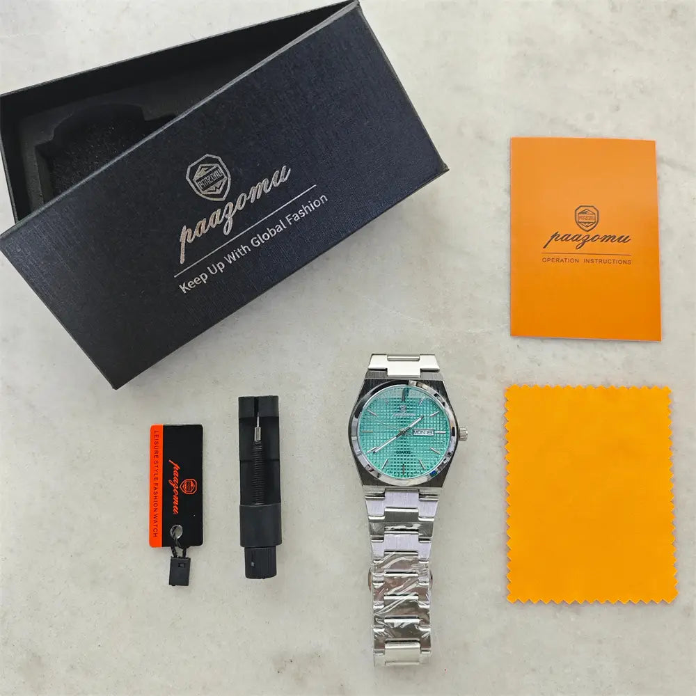 Paazomu luxury chronograph watch with a silver-toned case, turquoise face featuring a subtle grid pattern, and a sleek metallic link bracelet.