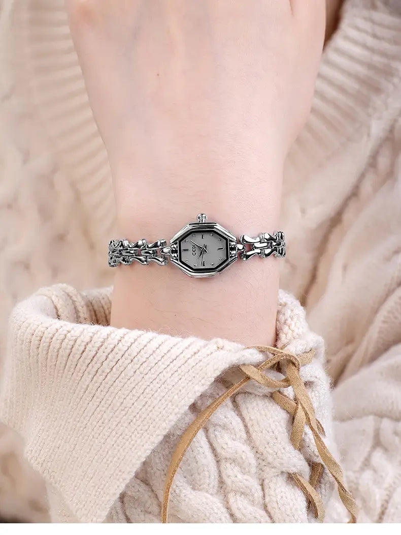 Silver octagonal-faced quartz wristwatch with an intricate linked bracelet design worn on a woman’s arm, inspired by the gold octagonal ladies luxury bracelet style.