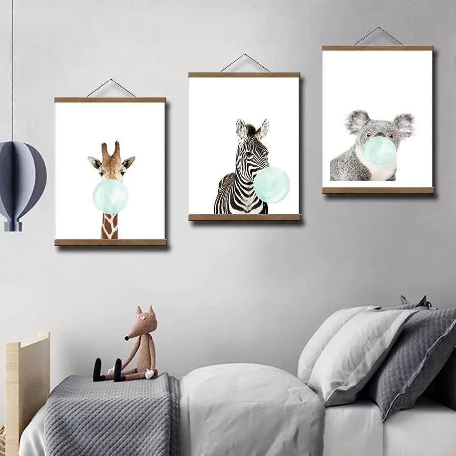 three framed animal prints featuring a giraffe, zebra, and koala each blowing a bubblegum bubble displayed in a teak wood magnetic photo frame poster hanger.