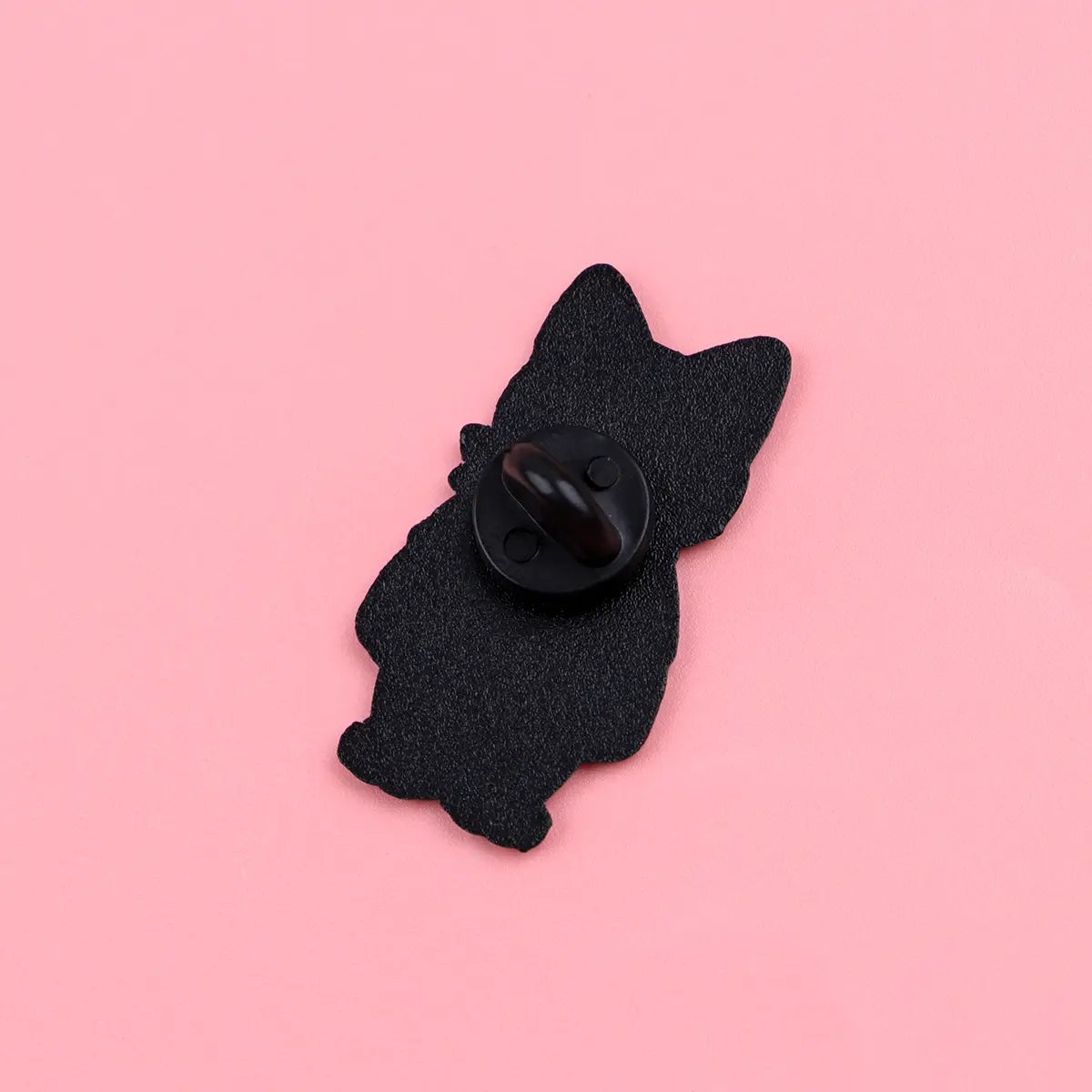 Black cat-shaped enamel lapel pin featuring a textured surface and a glossy black fastener shown from the back.