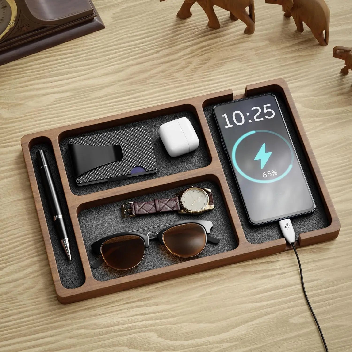 brown wooden desktop charging organizer tray with segmented compartments holding a smartphone watch sunglasses pen wallet and earbuds for efficient device storage and charging