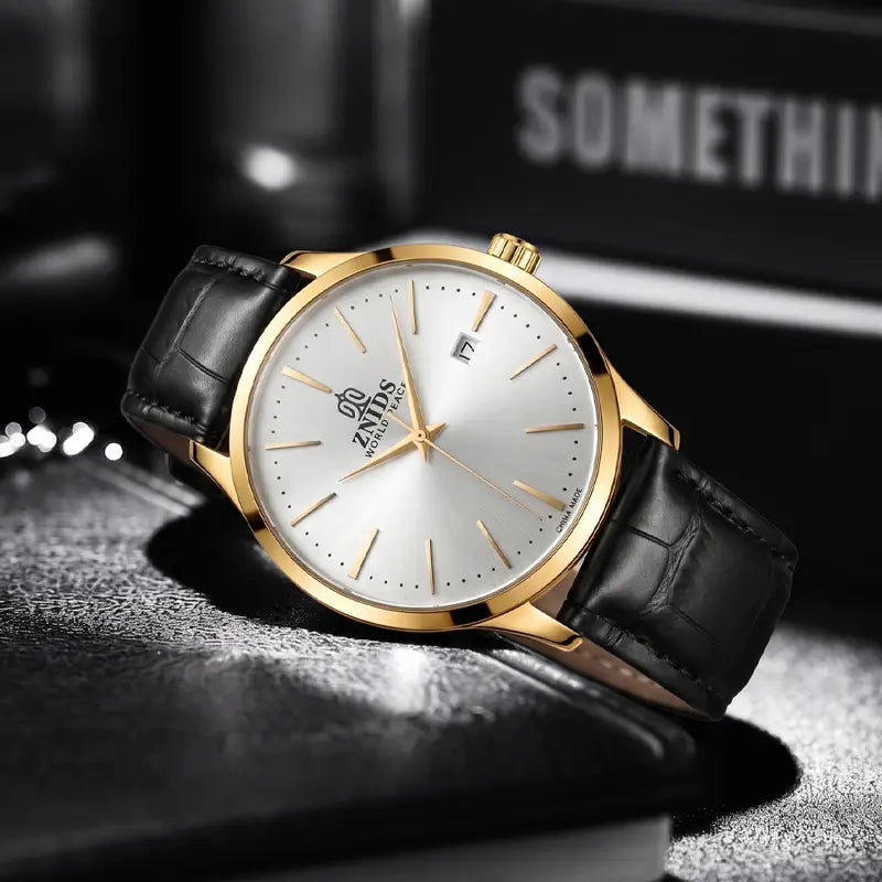 Gold-toned znids men’s automatic skeleton mechanical watch with silver dial, black crocodile-pattern leather strap, and date display.