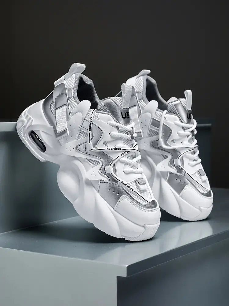 Men chunky air cushion casual sneakers in white and silver featuring a bold layered design with mesh panels and reflective accents.