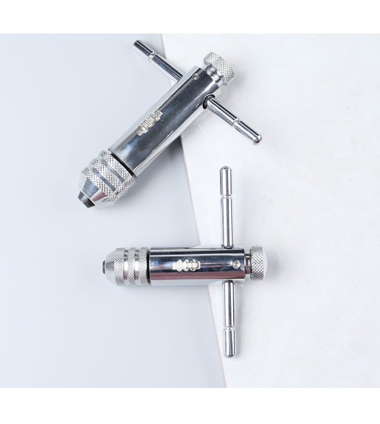 Two chrome-finished drill chuck key wrenches with textured knurled grips and t-shaped handles included in a tap and die set thread cutting tool kit
