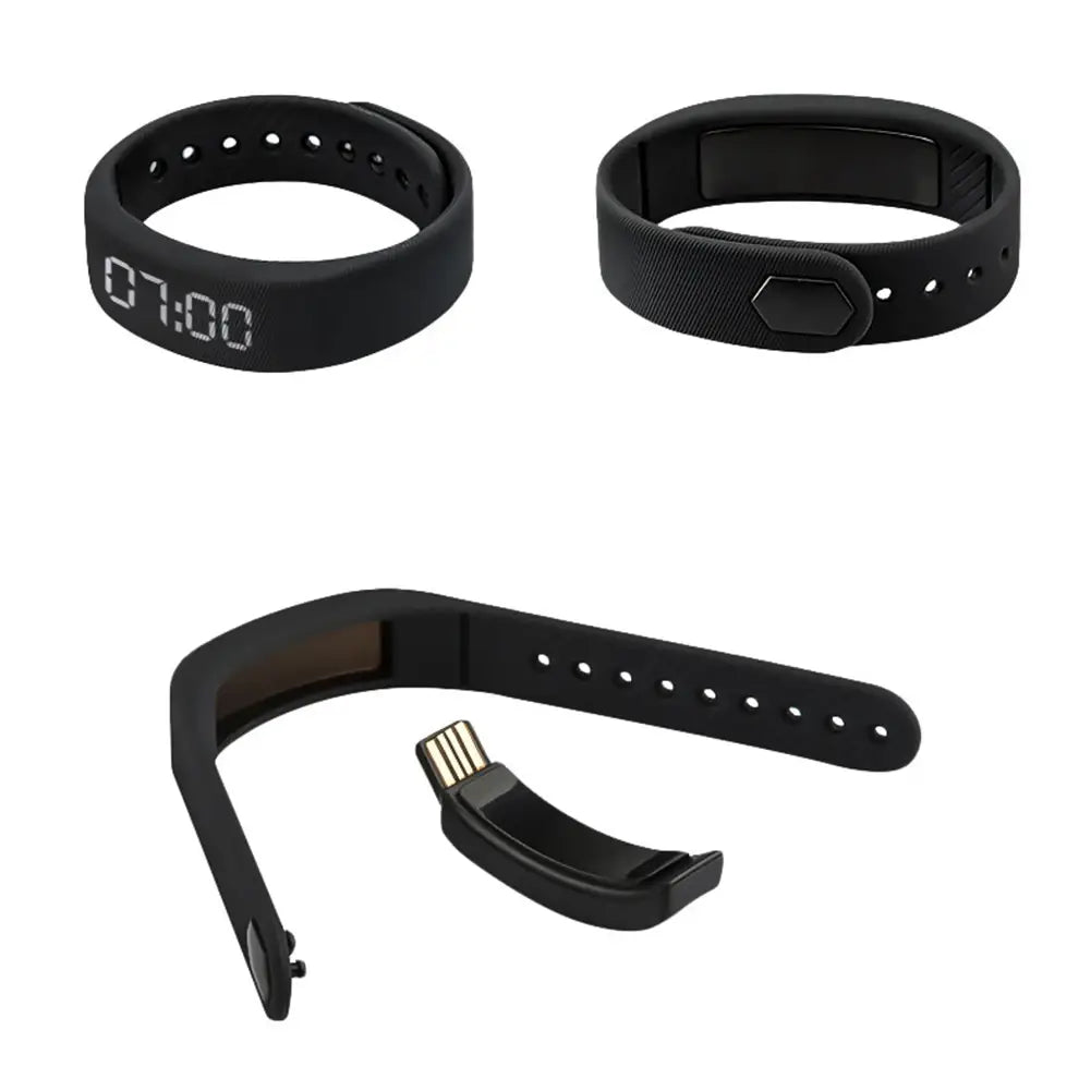 Black silicone kids led digital fitness tracker watch band with digital display and usb charging clip shown from the back side