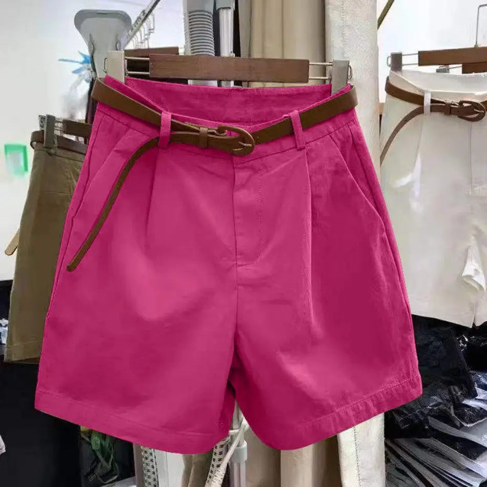 Bright pink women casual wide leg summer shorts with a brown leather belt featuring a circular buckle.