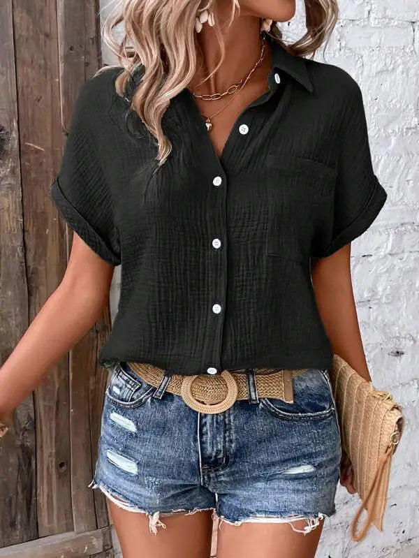 Black women cotton short sleeve button up shirt with subtle textured fabric and rolled cuffs.