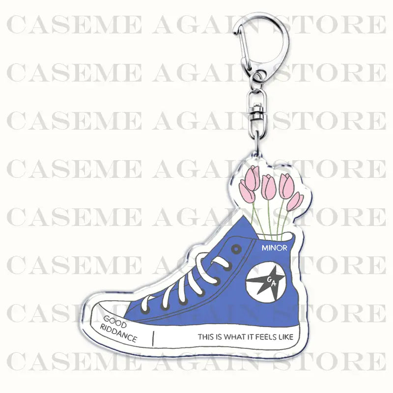 Blue acrylic Gracie Abrams Converse-style high-top sneaker keychain with white laces and a classic star logo featuring pink tulips emerging from the shoe’s opening anime fan gift
