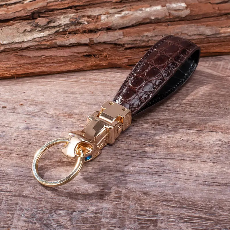 Brown crocodile-embossed leather leather tiger head keychain with gold-tone metal clasp and ring for luxury car key ring.