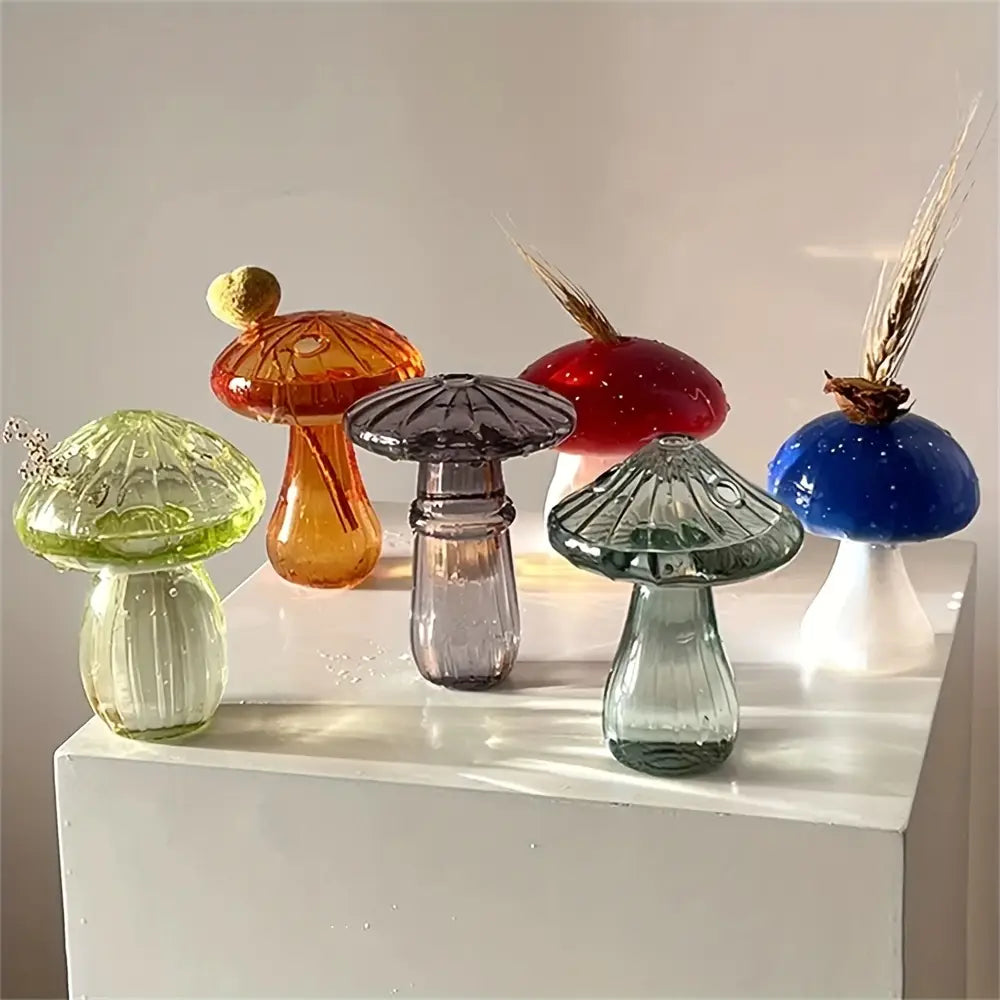 A collection of colorful glass mushroom bud vases featuring unique hues and textured caps designed as nordic plant holders.