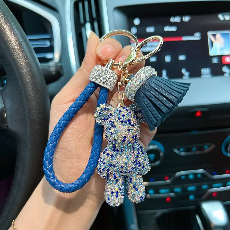 blue braided leather rhinestone bear keychain with a sparkling charm adorned in blue and clear rhinestones and a matching tassel.