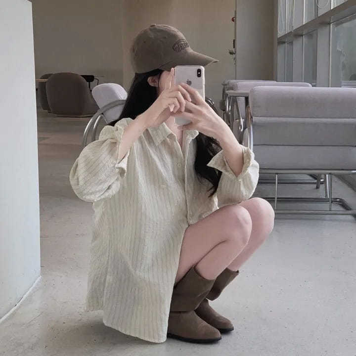 beige vertically striped long sleeve button down shirt with a relaxed fit featuring a versatile style and standard thickness striped pattern
