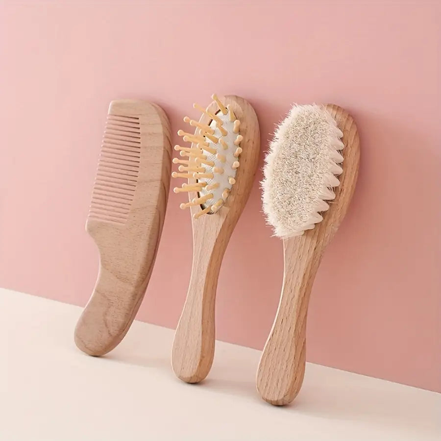 Set of three wooden hair care tools with natural wood handles and distinct brush types from baby wooden grooming set and healthcare kit.