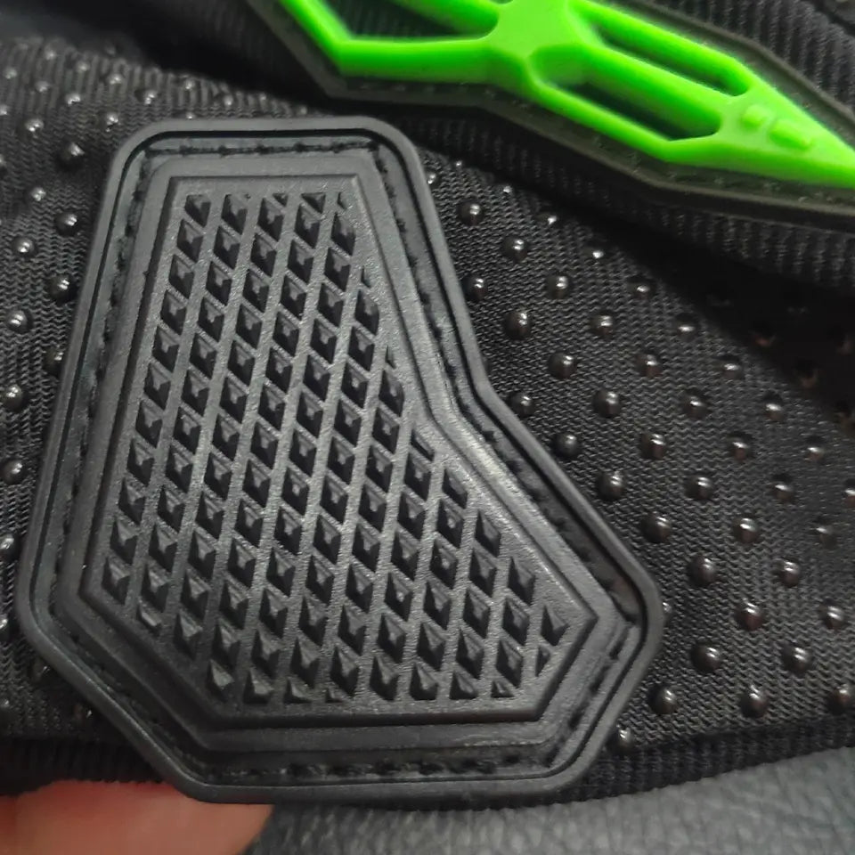 Black textured rubber footbed with diamond-patterned grip surface on the breathable protective motorcycle racing gloves.