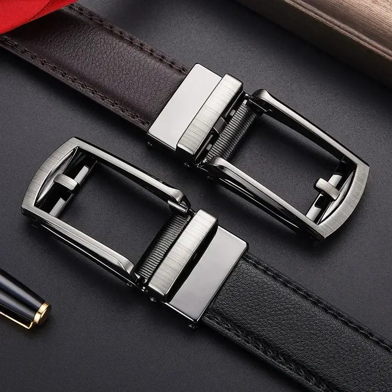 Two sleek silver automatic buckle assemblies with a brushed finish attached to black leather straps of mens automatic leather belt silver buckle.