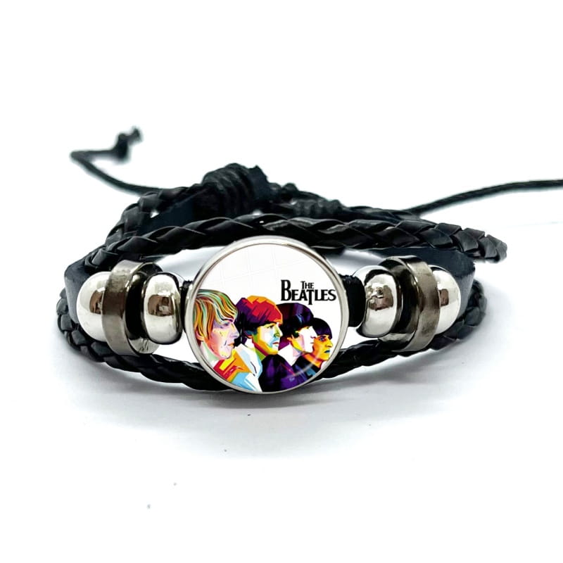 Black braided leather bracelet with a circular silver-toned bezel featuring a colorful portrait of the Beatles under a glass dome.