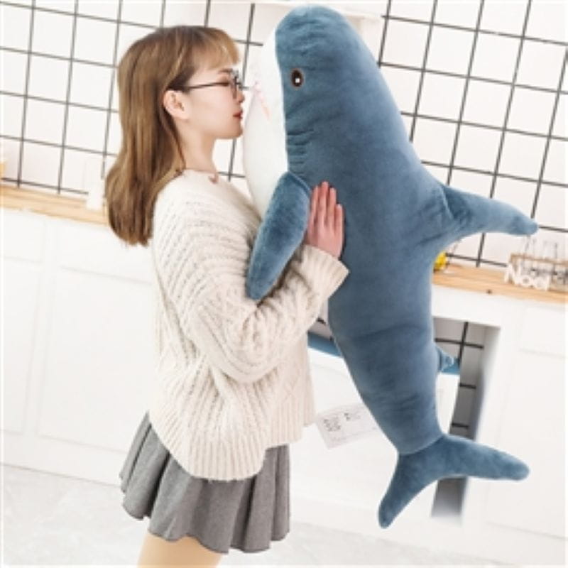 Plush blue shark stuffed animal pillow featuring a soft fabric blue dolphin design with a white underbelly and black eyes.